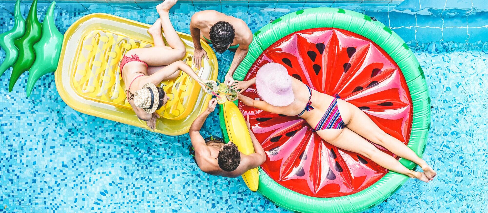 A group of people lounging on inflatable floats in a pool