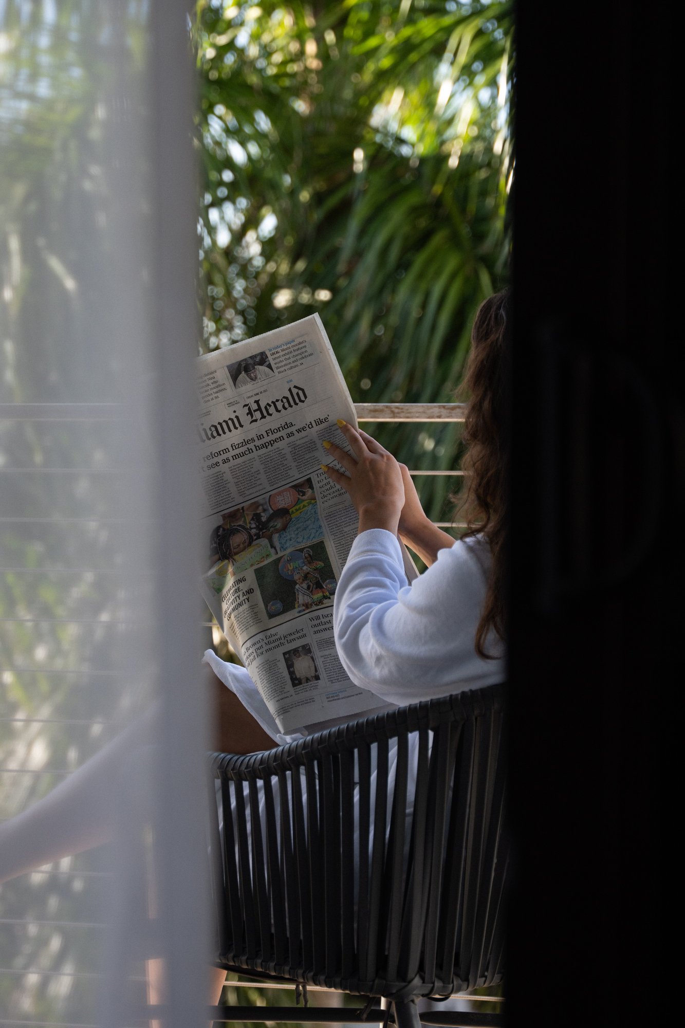 A lady reading newspapers
